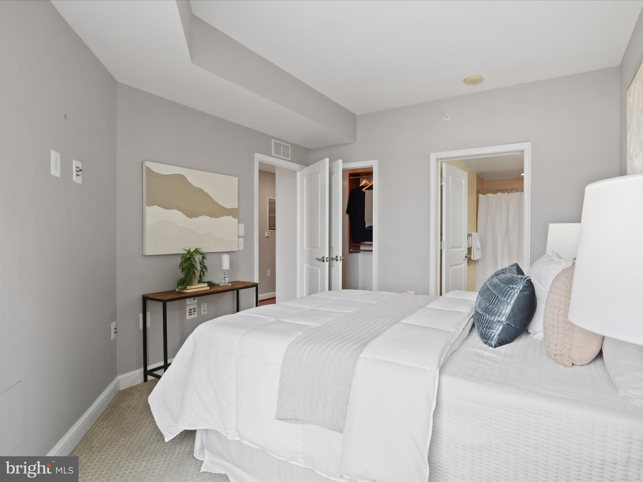 11990 Market Street, Unit 1406 Reston, VA 20190 - Photo 15 of 38 Primary bedroom and closet with built-ins