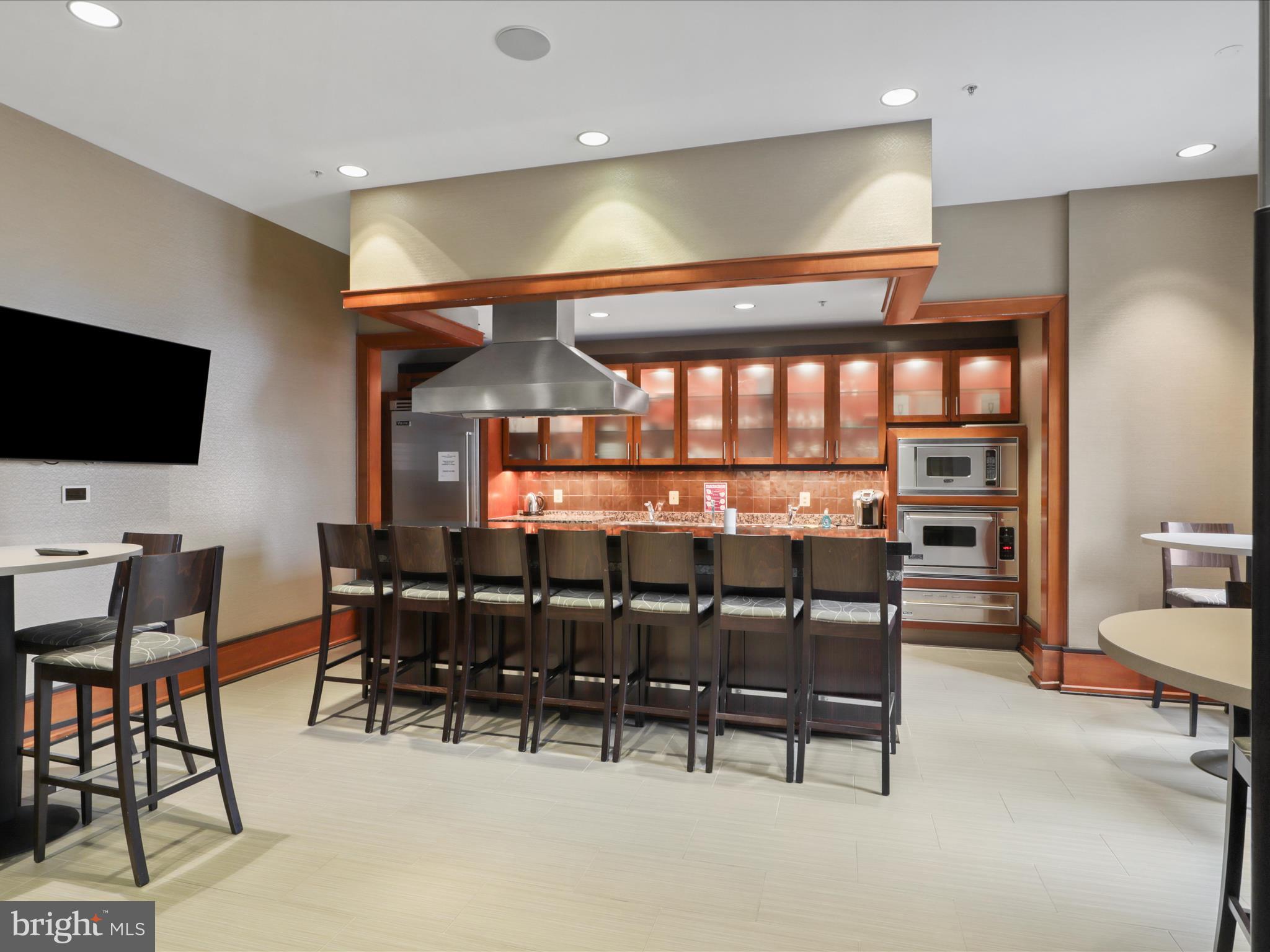 11990 Market Street, Unit 1406 Reston, VA 20190 - Photo 27 of 38 Kitchen for community use with television and bar