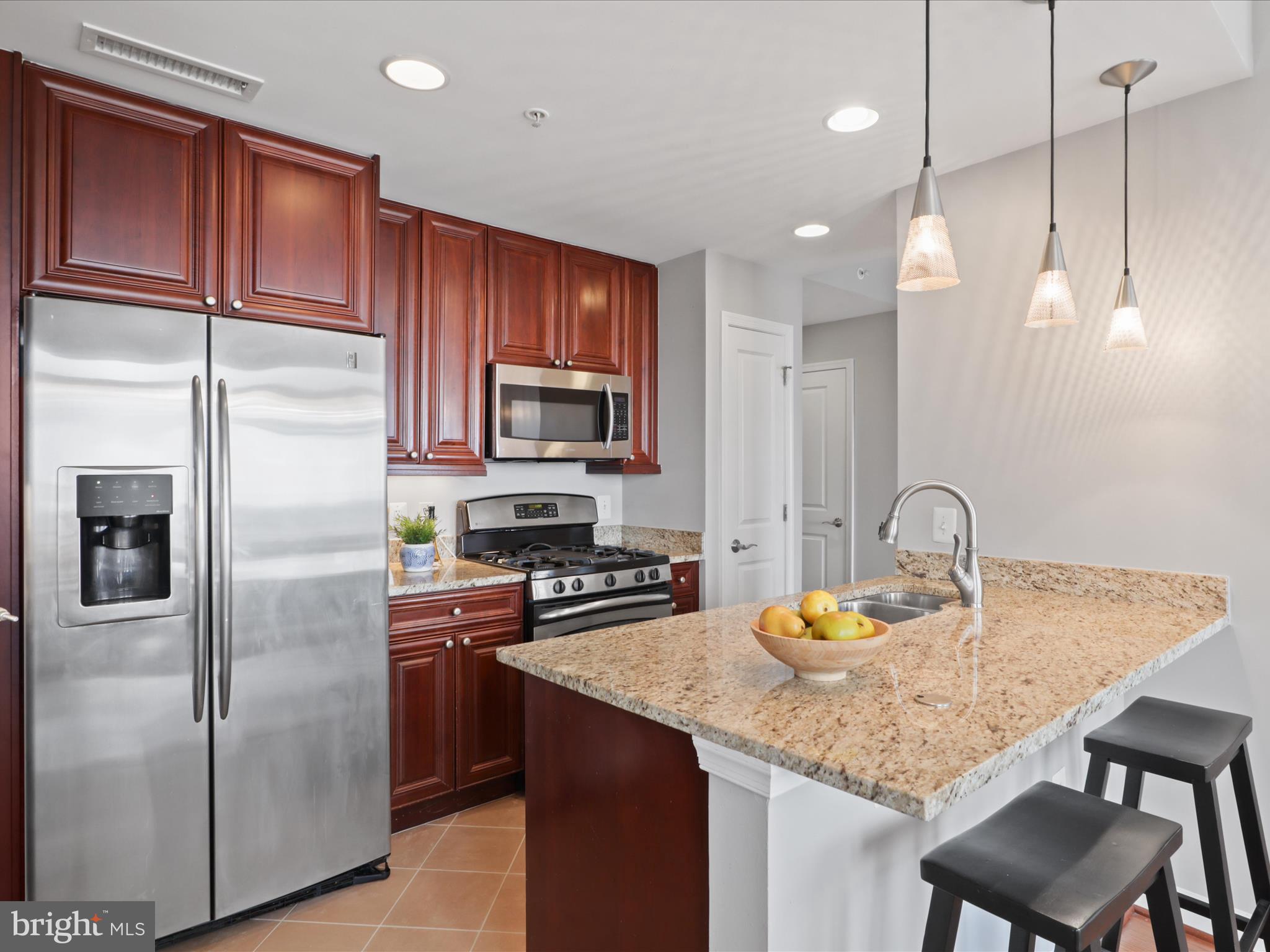 11990 Market Street, Unit 1406 Reston, VA 20190 - Photo 8 of 38 Kitchen bar with seating