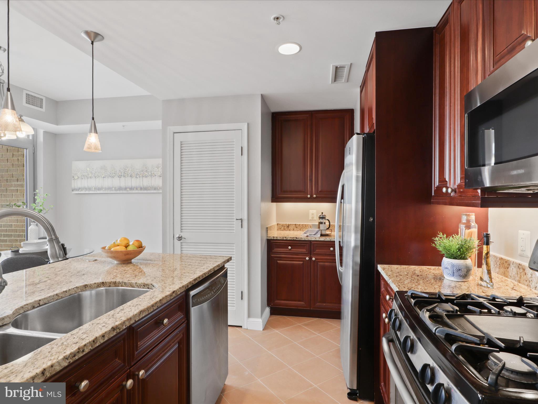 11990 Market Street, Unit 1406 Reston, VA 20190 - Photo 9 of 38 Kitchen with tile floor and pendant lighting