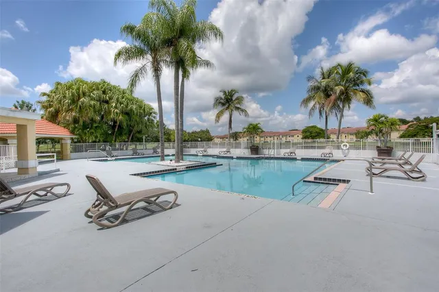 a view of swimming pool with outdoor seating and lake view