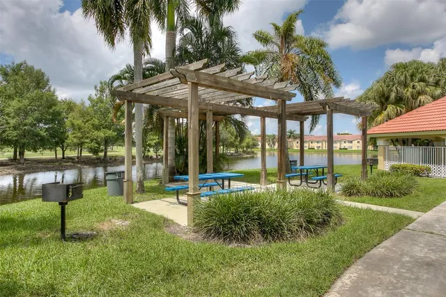 a view of a house with backyard and sitting area