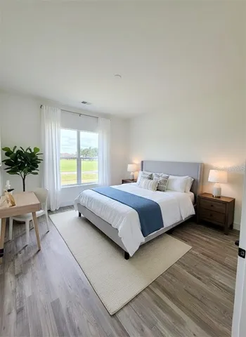 a bedroom with a bed and a couch