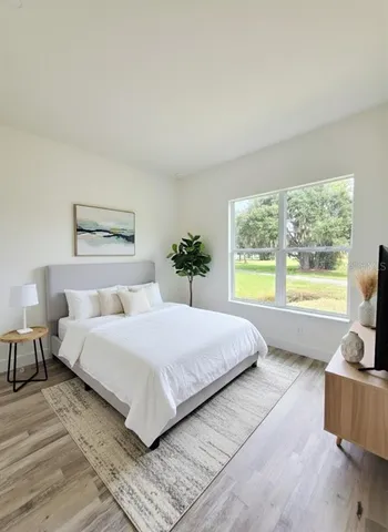 a bedroom with a large bed and a couch