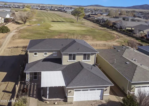 an aerial view of residential houses with outdoor space