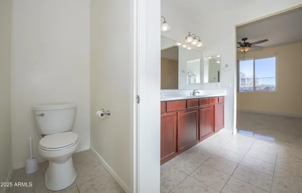 a spacious bathroom with a toilet sink and mirror