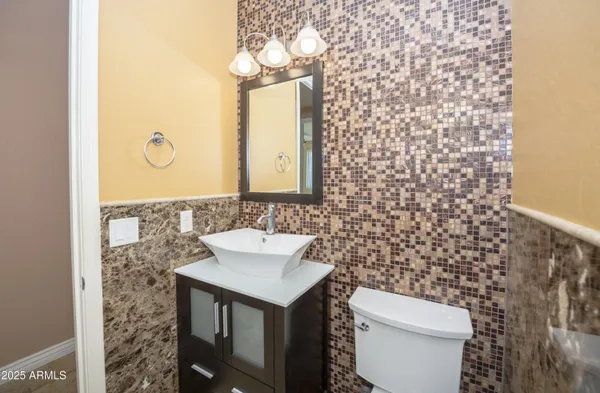 a bathroom with a sink a toilet and mirror