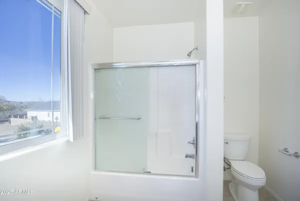 a bathroom with a shower and a toilet