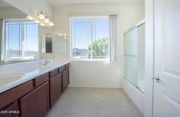 a bathroom with a double vanity sink and a mirror