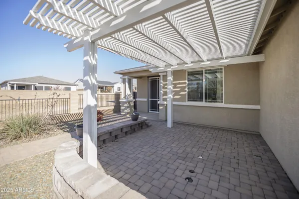 a view of a porch with furniture and a yard