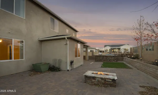 a backyard of a house with yard fire pit and outdoor seating