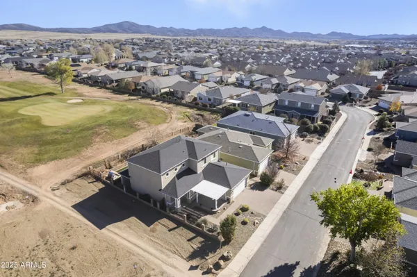 an aerial view of residential houses with outdoor space