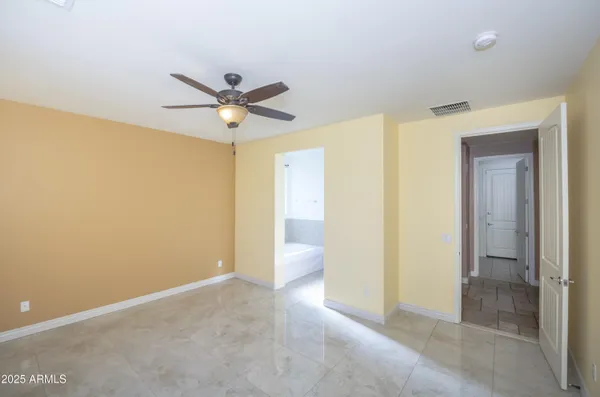 a view of a room with a ceiling fan and a bathroom