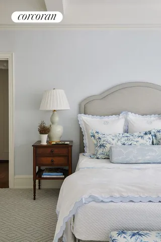 a bedroom with a bed and a lamp on table