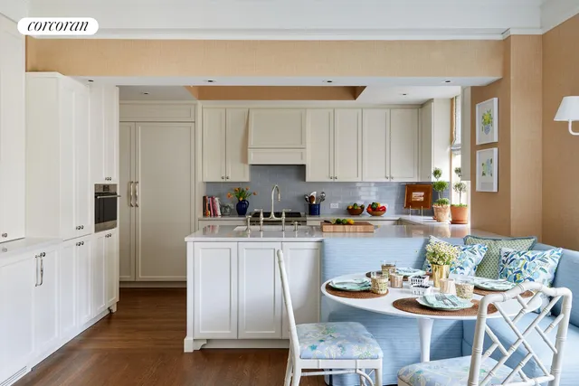 a kitchen with stainless steel appliances kitchen island granite countertop a table and chairs in it