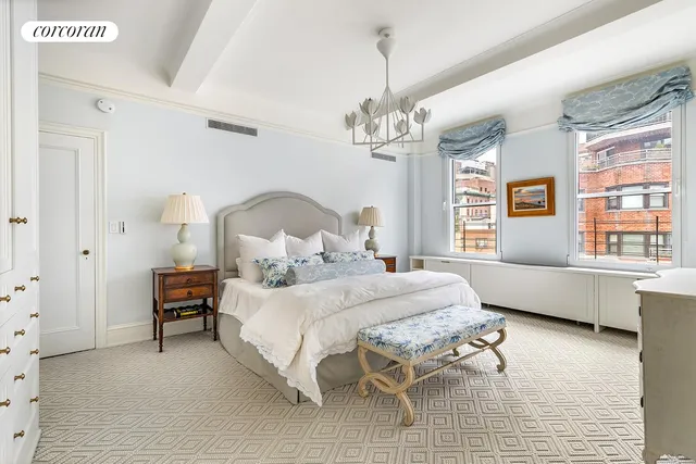 a bedroom with a bed wooden floor and windows