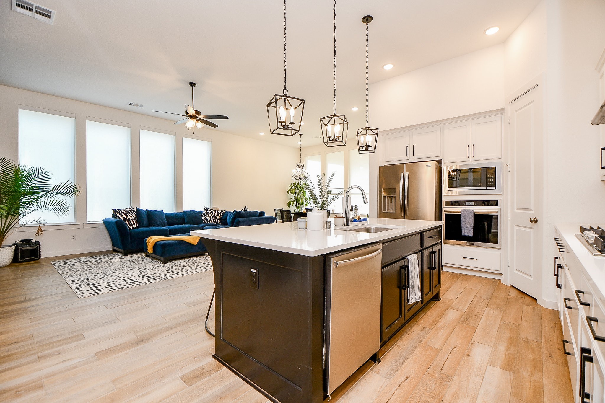 5102 Pomegranate Path Manvel, TX 77578 - Photo 12 of 33 a kitchen with stainless steel appliances granite countertop a sink a stove and a wooden floors