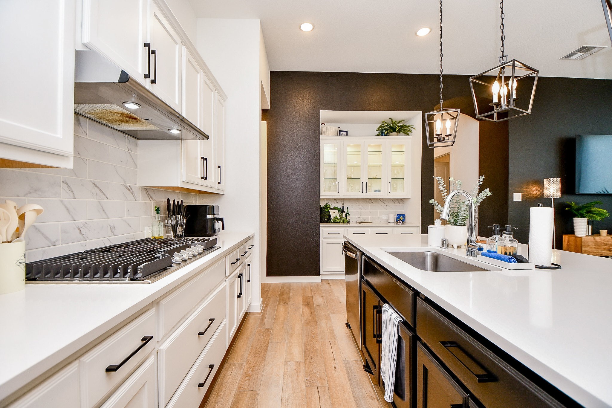 5102 Pomegranate Path Manvel, TX 77578 - Photo 14 of 33 a kitchen with stainless steel appliances a sink a stove and a wooden floors