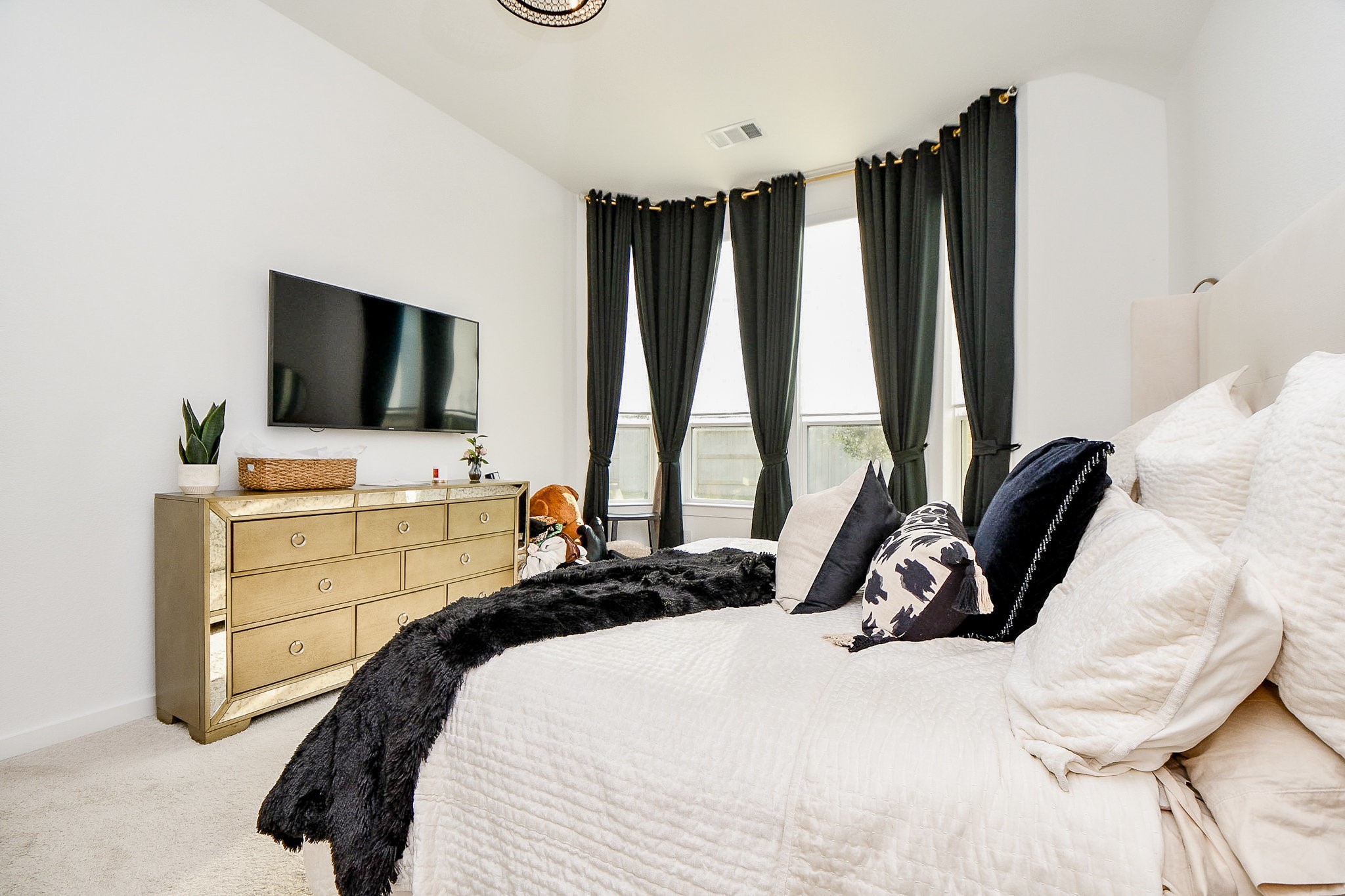 5102 Pomegranate Path Manvel, TX 77578 - Photo 21 of 33 a bedroom with a bed and flat tv screen on the dresser