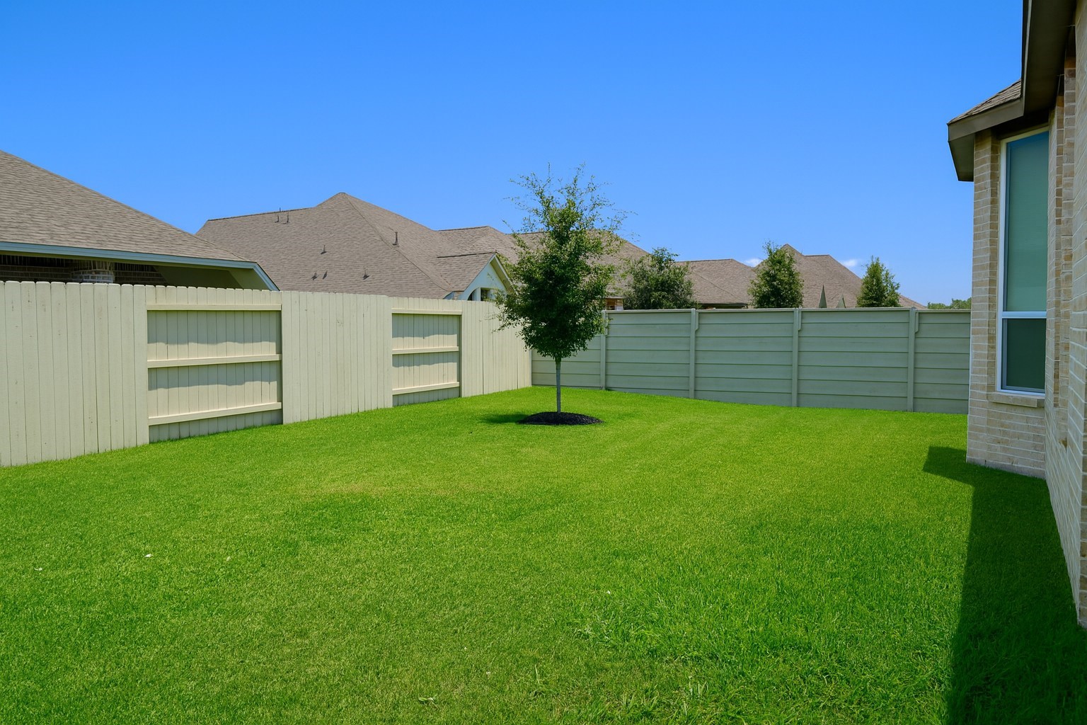 5102 Pomegranate Path Manvel, TX 77578 - Photo 32 of 33 a view of a backyard with a garden and entertaining space