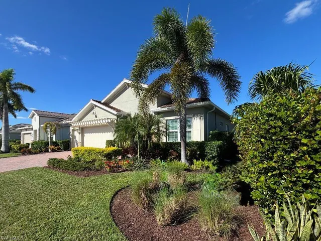 a view of a house with a yard and plants