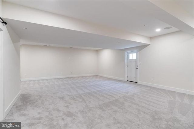 an empty room with window in back and white door