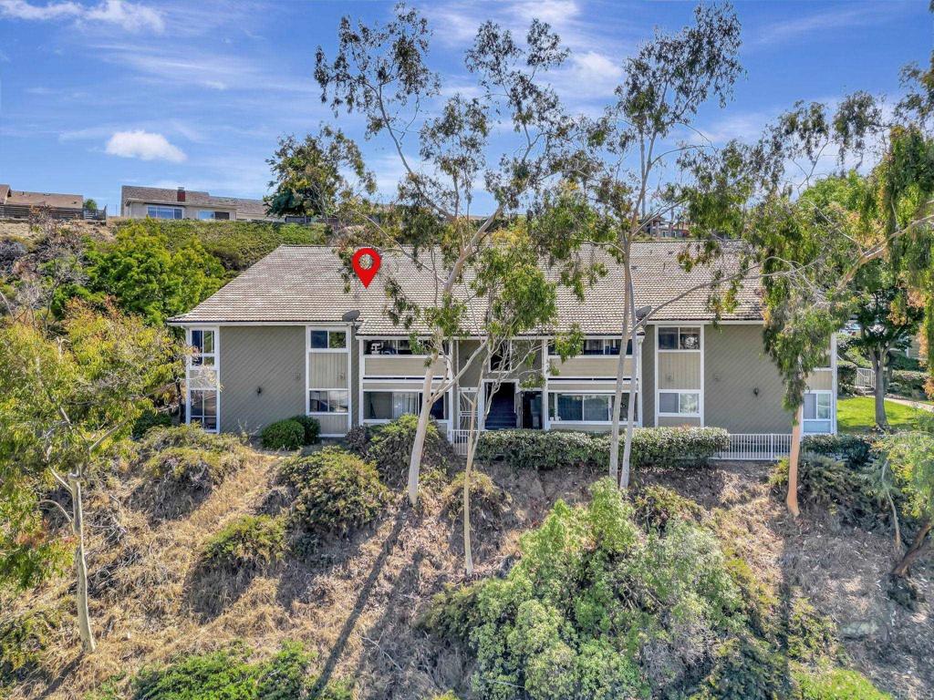 548 Telegraph Canyon Road, Unit D Chula Vista, CA 91910 - Photo 1 of 1 a house covered with tall trees