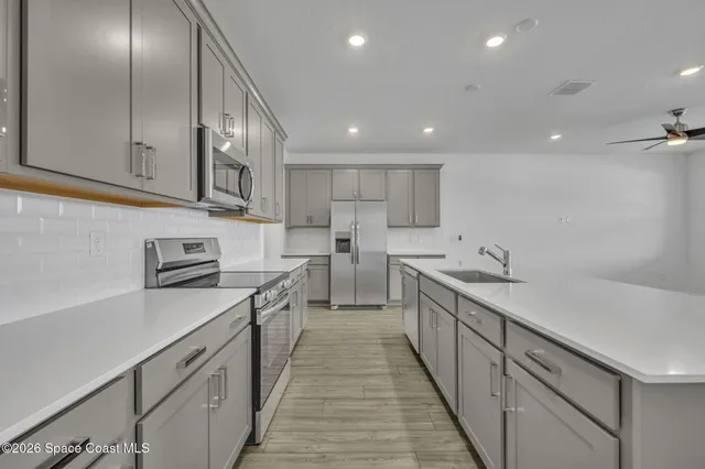 a kitchen with stainless steel appliances granite countertop counter space a sink and cabinets