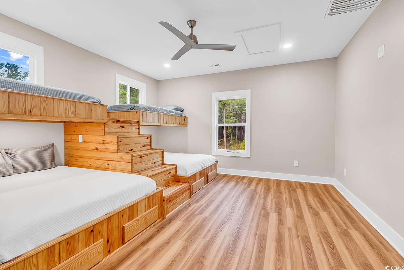 32 Old Place Kingstree, SC 29556 - Photo 17 of 40 Bedroom with multiple windows, a ceiling fan, light wood-type flooring, attic access, and recessed lighting