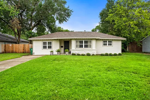 a front view of house with a garden and patio