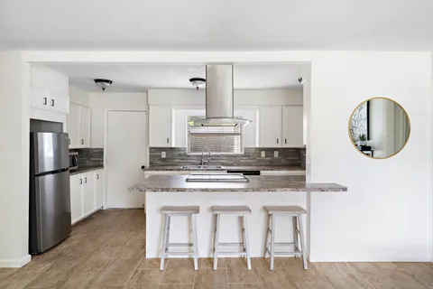 a kitchen with a stove a refrigerator and a sink