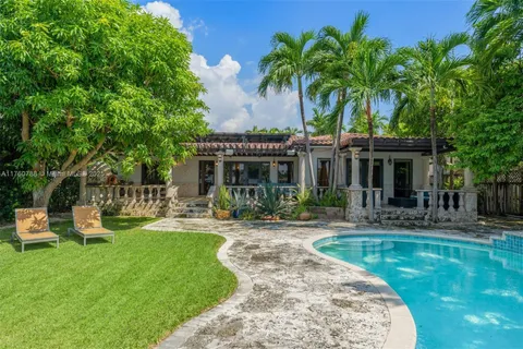 a front view of a house with garden and porch