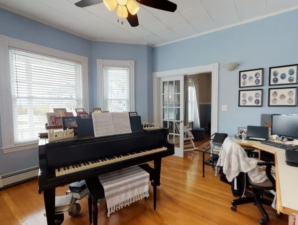 a living room with furniture and a wooden floor