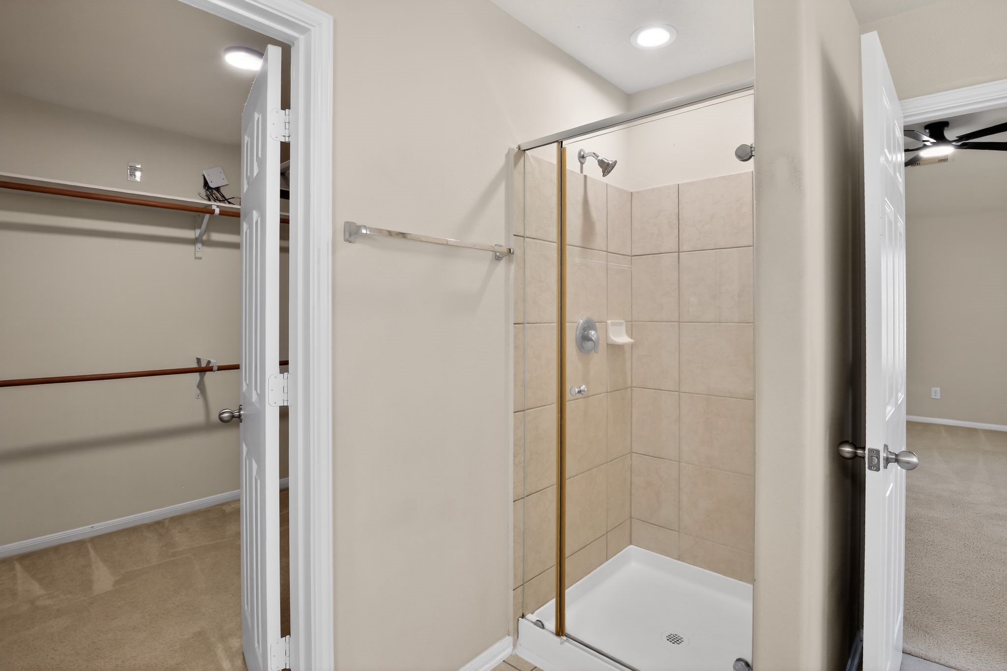4938 Yearling Ridge Court Katy, TX 77449 - Photo 16 of 29 a bathroom with a glass shower door