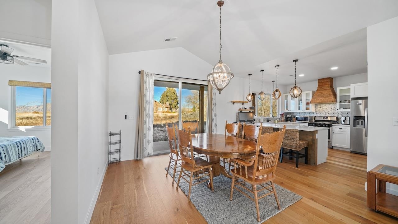 3439 D Road Palisade, CO 81526 - Photo 7 of 29 a view of a dining room and livingroom with furniture wooden floor a chandelier