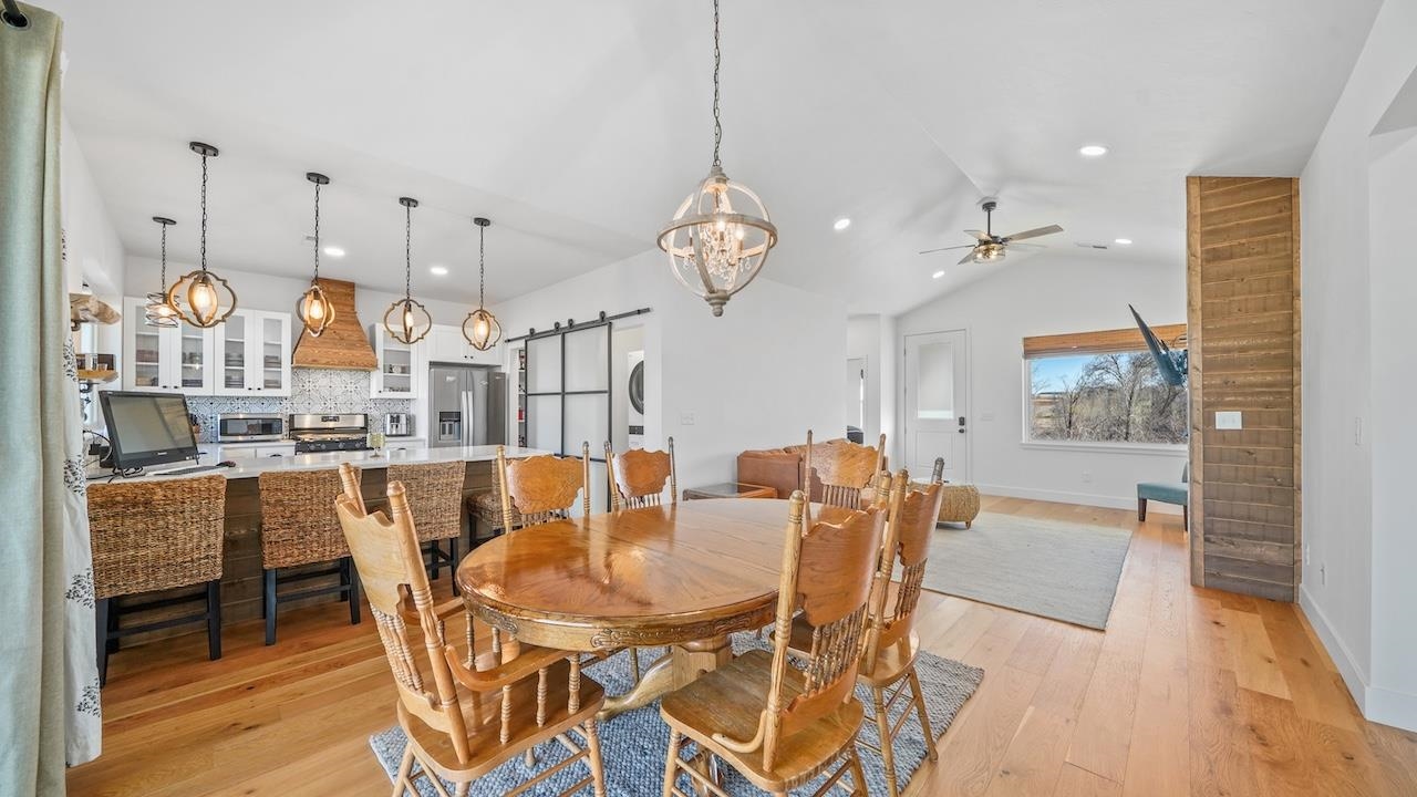 3439 D Road Palisade, CO 81526 - Photo 8 of 29 a view of a dining room with furniture large window and wooden floor