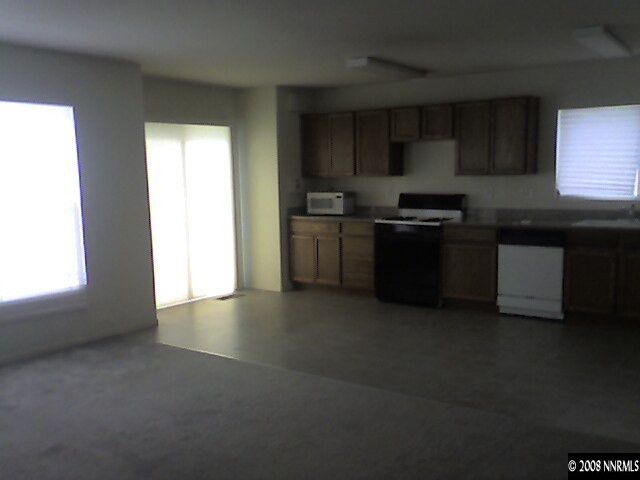 7636 Corso Street Reno, NV 89506 - Photo 3 of 8 a kitchen with stainless steel appliances granite countertop a stove a sink and a refrigerator