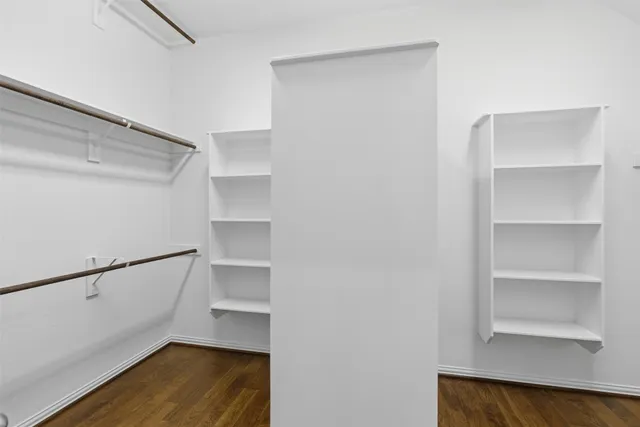 a view of walk in closet with empty racks