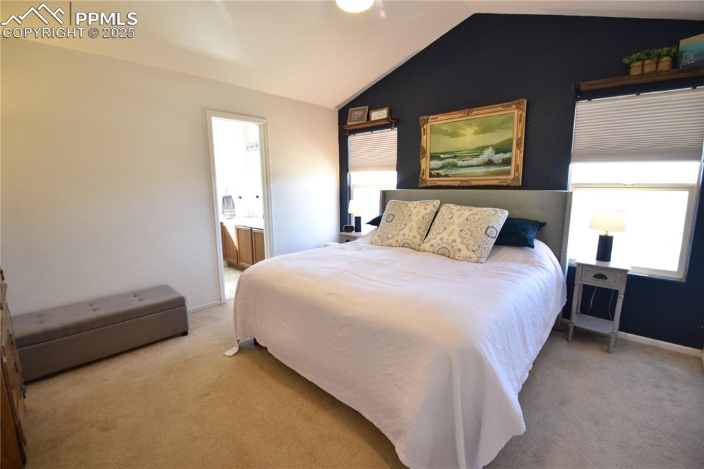 9332 Bethpage Road Peyton, CO 80831 - Photo 11 of 32 a bedroom with a bed and a tv on dresser