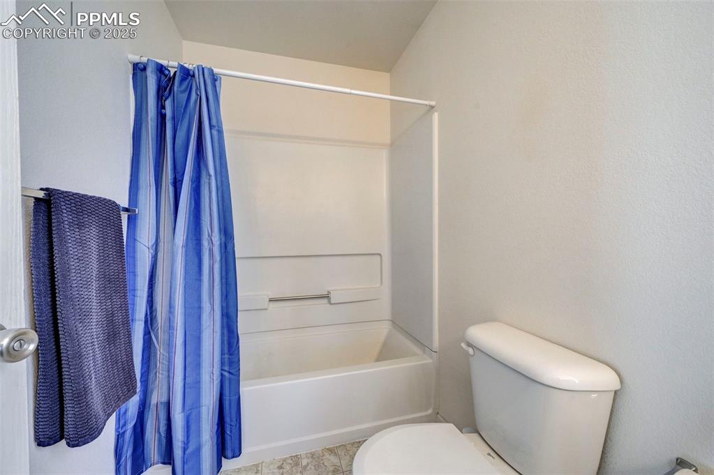 9332 Bethpage Road Peyton, CO 80831 - Photo 16 of 32 a bathroom with a shower a toilet and a sink