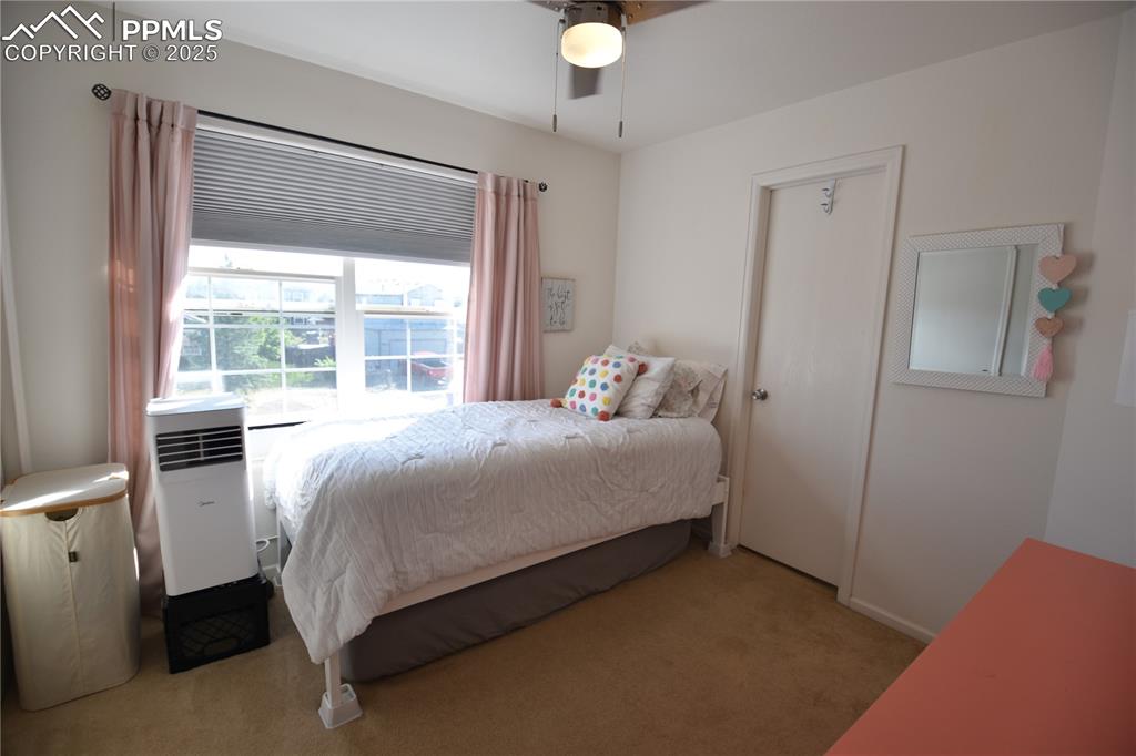 9332 Bethpage Road Peyton, CO 80831 - Photo 18 of 32 a bedroom with a bed and a window