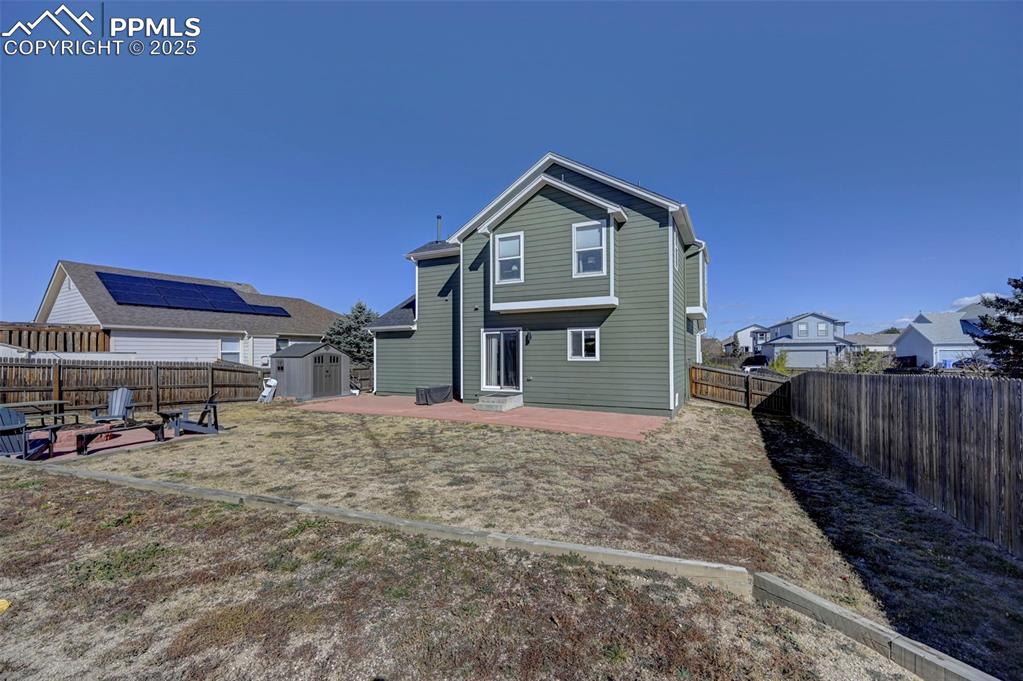 9332 Bethpage Road Peyton, CO 80831 - Photo 29 of 32 a front view of a house with a yard and garage