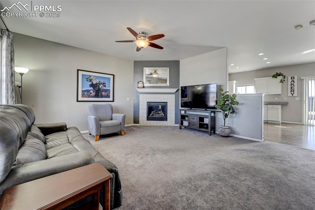 9332 Bethpage Road Peyton, CO 80831 - Photo 3 of 32 a living room with furniture and a flat screen tv