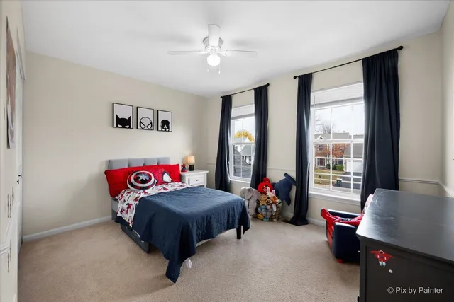 a bedroom with bed and a chandelier