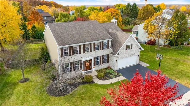 a aerial view of a house with table and chairs and potted plants