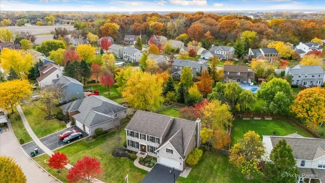an aerial view of residential houses with outdoor space
