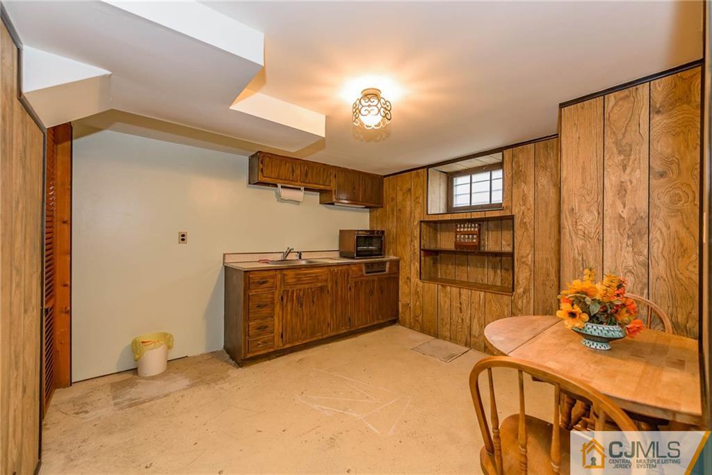 1 Estok Road Edison, NJ 08817 - Photo 22 of 25 a kitchen with a refrigerator a stove top oven a sink and dishwasher