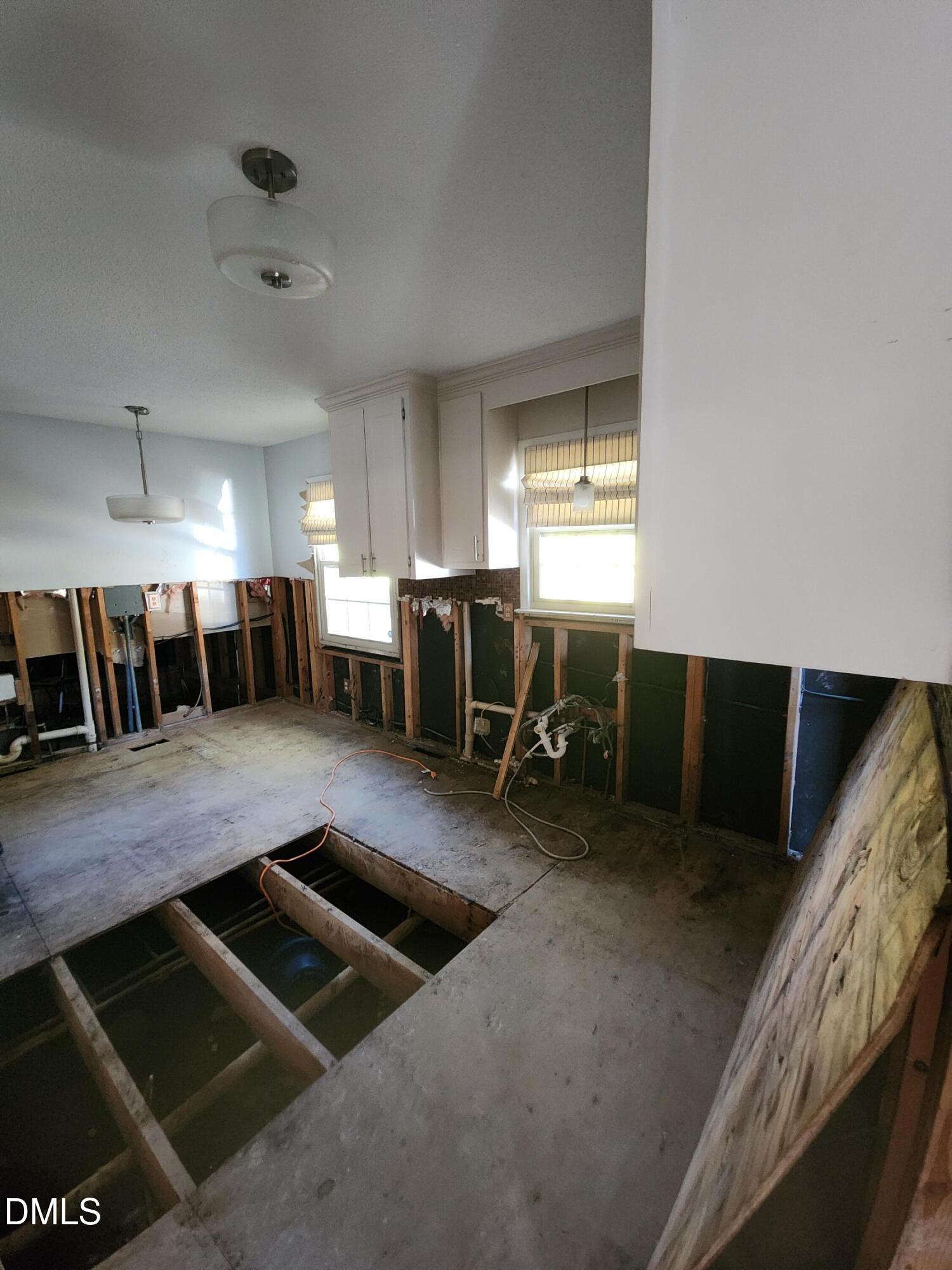 309 Rippling Stream Road Durham, NC 27704 - Photo 11 of 36 a view of kitchen and dining room with wooden floor