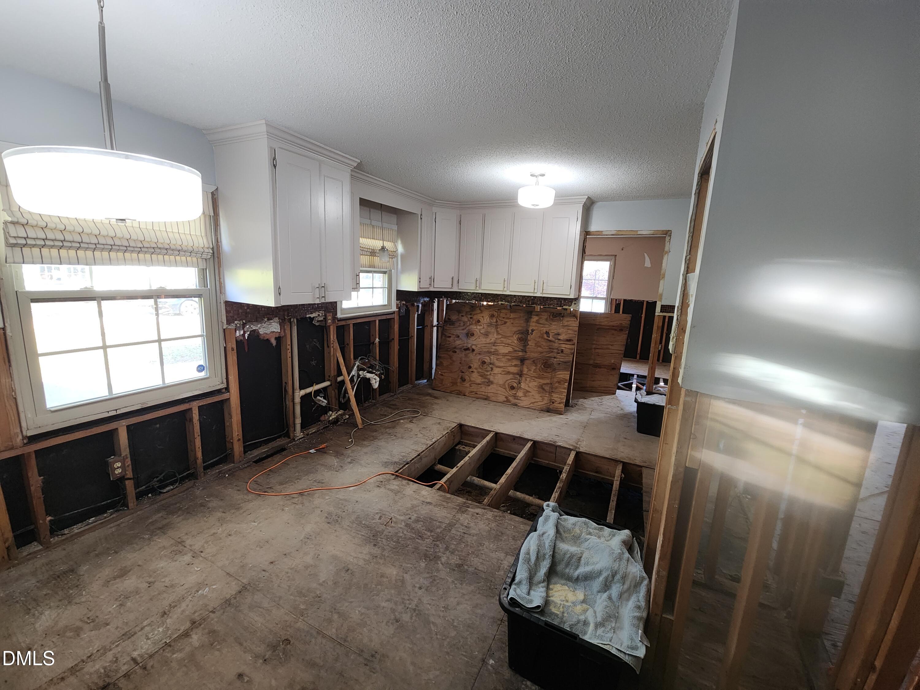 309 Rippling Stream Road Durham, NC 27704 - Photo 12 of 36 a room with furniture a window and gym equipment