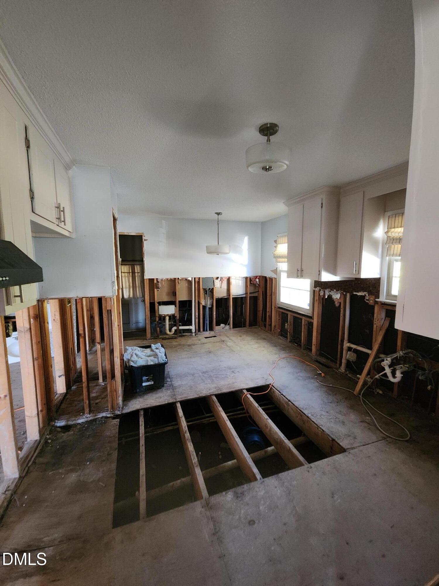 309 Rippling Stream Road Durham, NC 27704 - Photo 14 of 36 a living room with lots of furniture and a view of kitchen